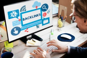 Person working on a computer with a screen showing the word BACKLINKS and SEO-related icons, illustrating backlink strategies.