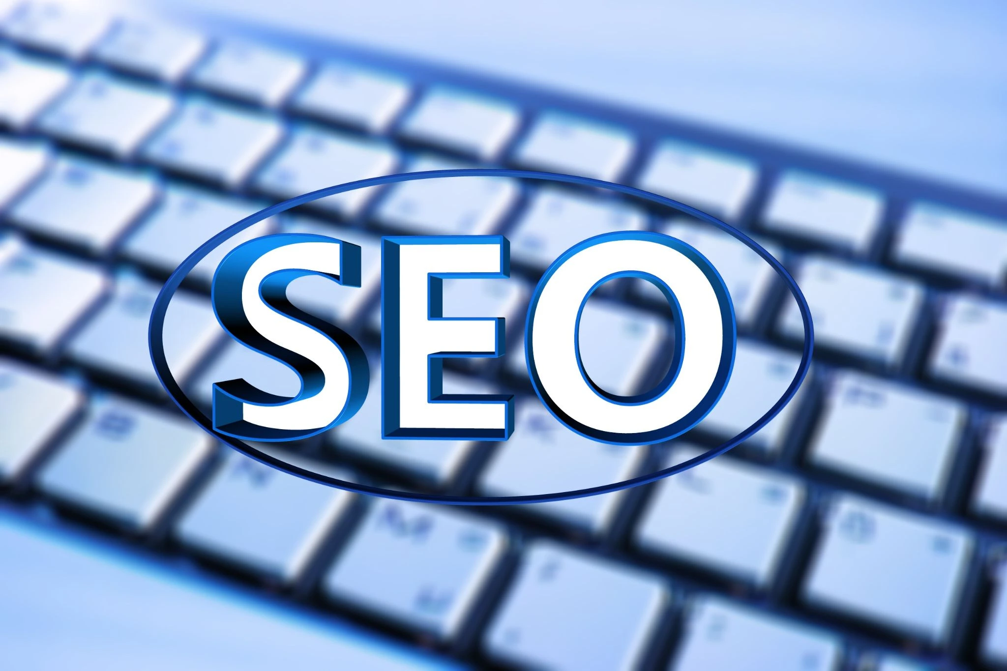 Glowing blue SEO graphic on a laptop keyboard for professional SEO Pakistan services.