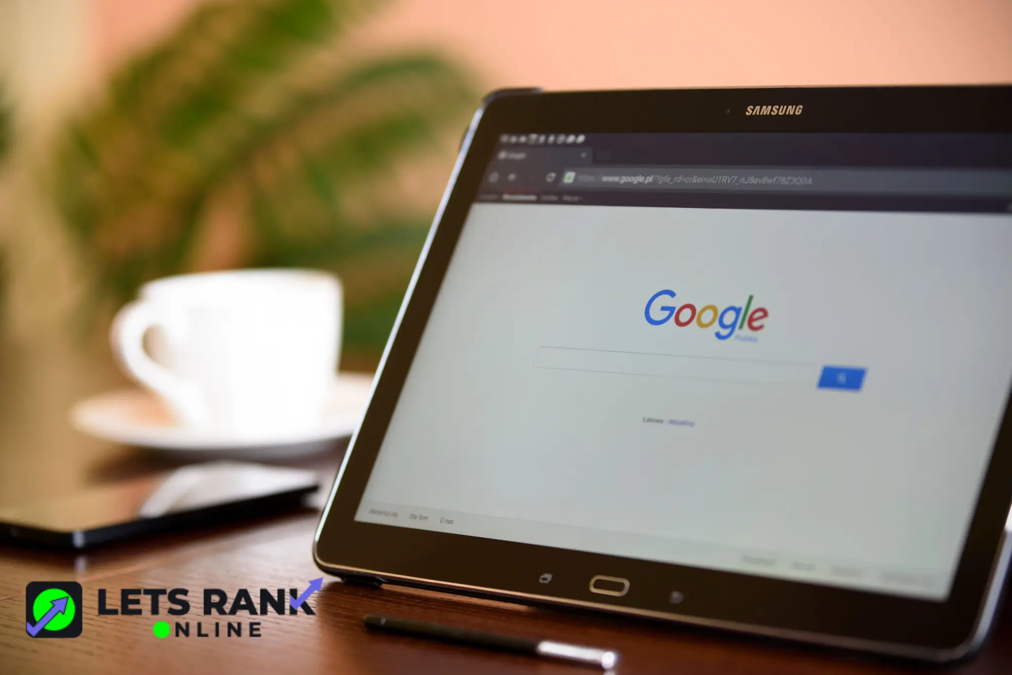 Laptop displaying the Google homepage next to a white coffee cup for Google Business Profile Optimization.